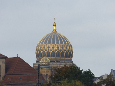 Foundation New Synagogue  The Neue Synagoge ("New Synagogue") was built 1859–1866 as the main synagogue of the Berlin Jewish community, on Oranienburger Straße. Because of its splendid eastern Moorish style and resemblance to the Alhambra, it is an important architectural monument of the second half of the 19th century in Berlin. One of the few synagogues to survive Kristallnacht, it was badly damaged prior to and during World War II and subsequently much was demolished; the present building on the site is a reconstruction of the ruined street frontage with its entrance, dome and towers, and only a few rooms behind. It is truncated before the point where the main hall of the synagogue began.