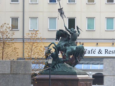 St. George fighting the dragon.  The largest monument in Nikolaiviertel is a statue of St. George fighting the dragon. The statue was created in 1853 by the German sculptor August Kiss and originally adorned a courtyard of the Stadtschloss, the majestic Berlin city palace. It now occupies a spot on a small square near the river Spree.