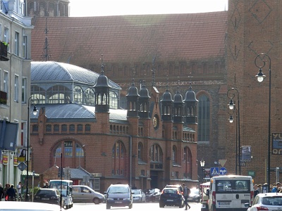 Market Hall at Dominikański Square  In 1894, it was decided to build a Market Hall, which was put into use on 3 August 1896  , to liquidate street trade. In 1999, during the last renovation, the remains of the market settlement, the foundations of the Romanesque church of Sts. Nicholas (dating back to 1170), a church cemetery with more than 400 burials and remnants of the foundation of the Dominican monastery. The monuments found have been partially secured and covered with floor and are now partially exposed in the lower part of the hall [3] . During the three years of archaeological work, the remains of several thousand buried Gdansk have been found under the hall and under the surface of Dominikański Square. From the beginning of 2001 to August 2005 the hall was closed and underwent a major overhaul with restoration [5] . The basement hall, with exposed monuments from the 12th century