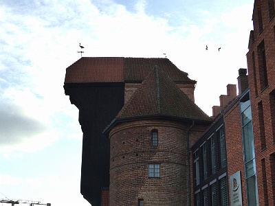 The medieval port crane, called Żuraw (Crane) , over the river Motława  Part of the National Maritime Museum, the oh-so conspicuous Gdańsk Crane (Żuraw) rises above the waterfront. Built in the mid-15th century as the biggest double-towered gate on the shoreline, it also served to shift heavy cargo directly onto vessels docked at the quay. Incredibly, this people-powered device could hoist loads of up to 2000kg, making it the largest crane in medieval Europe. Early-17th-century wheels were added higher up for installing masts.Blasted to pieces in 1945, everything was carefully put back together in the postwar decades, making it the only fully restored relic of its kind in the world. Inside you’ll find exhibits relating to the history of shipping, plus a collection of shells, coral and other marine life;