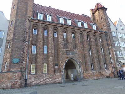 Mary's Gate  Mariacka Gate - historic , one of the gates of the Main Town of Gdansk . It is located on the Motlawa River at Długie Pobrzeze , at the outlet of Mariacka Street and next to the House of the Natural Society .The gate has late Gothic forms. It was probably built in the last quarter of the 15th century (first mentioned in 1484 ), on the plan of an elongated rectangle about 25 m × 7.3 m, closing the outlet of Mariacka Street. From the adjacent Chlebnicka Gate differs from the larger asymmetry and more massive, octagonal turrets flanking the east façade .In the 16th century the gate lost its military significance and was rebuilt into flats. After considerable destruction in 1945 , the gate was rebuilt in 1958-1996 and was used for the Archaeological Museum .