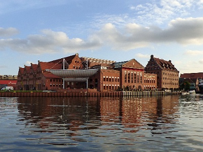 Polish Baltic Philharmonic Concert Hall  The building, which houses the Baltic Philharmonic Hall today was constructed in 1897-1898 as a power station with a neo-Gothic façade. The seat of the Polish Baltic Philharmonic is a complex of buildings at the former plant of the late nineteenth century, located on the island of Ołowianka in Gdańsk. After the plant was closed in 1996, it was subsequently adapted between 1996-2005 as a concert hall. This urban power station was built between 1897-1898 by the Berlin firm of Siemens & Halske, with further expansion continuing through 1913. This brick building with its elegant neo-Gothic façade is decorated with rosettes, turrets and even two tower. During the final months of World War II, the complex suffered severe damage. Launched back in August 1945 the power plant operated until its closure in 1996. The Baltic Philharmonic is composed of seven segments, including:     the main concert hall of 1,000 seats,  chamber music hall for 200 seats, two multi-purpose halls, foyer (exhibition room, 808 sq ft), hotel for 60