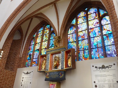 St. Adalbert's Chapel  The chapel is located on the axis of the cathedral. The wardrobe of the triptych contains a sixteenth-century figure of Our Lady of Apocalyptic (Maria stands on the sorrow of the moon, symbolizing the victory over the forces of evil and Satan) from the Mariacki Church in Chojna . Next - St. Wojciech (paddle attribute). At the altar there is a reliquary with relics of St. Wojciech; and above the altar - a sculpture depicting Michael the Archangel from the 17th century, which once crowned the canopy of the cathedral pulpit (pulpit has not survived). In the floor of the chapel there is an entrance to the burial crypt of the Szczecin bishops. Over the chapel - huge (80 square meters area) stained glass founded on the occasion of the pilgrimage of Pope John Paul II to Szczecin.